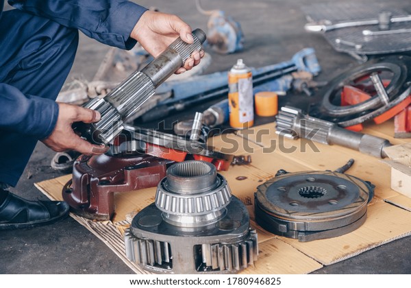 Mechanic check collect detailed information\
during work. Repairing a tractor used in agriculture. service,\
repair, maintenance.