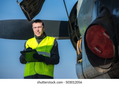 Mechanic checking airplane's engine