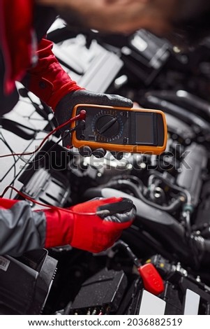 Similar – Image, Stock Photo Anonymous repairman examining car exhaust system in garage
