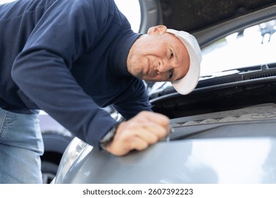 Mechanic checking a car engine compartment