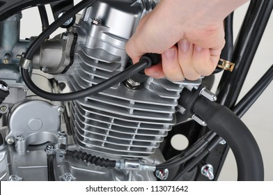 Mechanic Checking The Spark Plug Lead On A Motorcycle