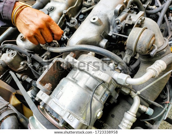 The\
mechanic is checking the truck engine before\
use