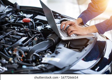 Mechanic Checks The Car Engine With Electronic Tools. Modifying The Engine With A Computer Check Service