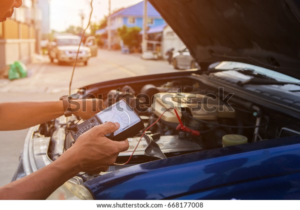 mechanic checks electronics\
car