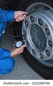 A Mechanic Checks The Tire Pressure Gauge Truck	