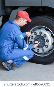 A Mechanic Checks The Tire Pressure Gauge Truck