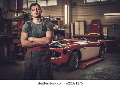 Mechanic In Classic Car Restoration Workshop