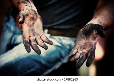 mechanic with dirty hands after fixing the brakes