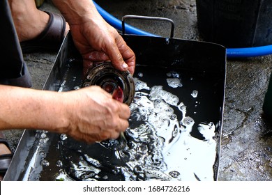 Mechanic to do motorcycle spare parts with oil - Shutterstock ID 1684726216