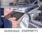 mechanic is doing the annual car inspection. Car repair shop is ready to serve. Car mechanic inspects car engine problems technical inspection engine safety Maintenance Changing the engine oil
