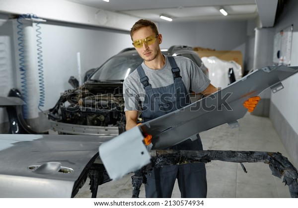 Mechanic\
engaged auto part assembly after\
painting