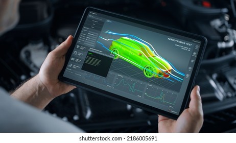 Mechanic engineer holding a digital tablet with engineering research software application on the screen, aerodynamic test of parameters data in the wind tunnel of an eco-friendly car body - Shutterstock ID 2186005691
