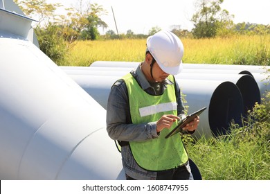 Mechanic Engineer Holds An IPad In A Champagne Bucket Factory