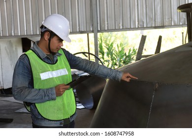 Mechanic Engineer Holds An IPad In A Champagne Bucket Factory