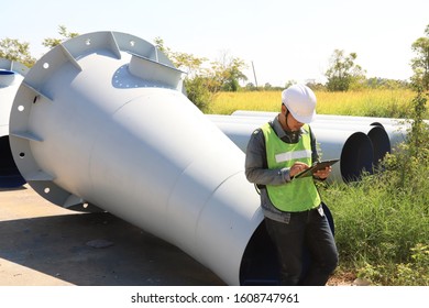 Mechanic Engineer Holds An IPad In A Champagne Bucket Factory