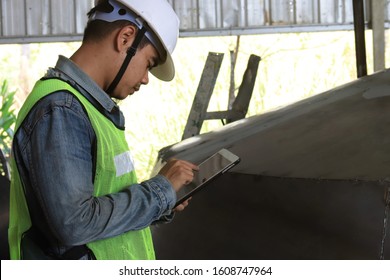 Mechanic Engineer Holds An IPad In A Champagne Bucket Factory