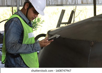 Mechanic Engineer Holds An IPad In A Champagne Bucket Factory