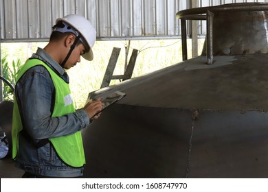 Mechanic Engineer Holds An IPad In A Champagne Bucket Factory