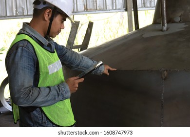 Mechanic Engineer Holds An IPad In A Champagne Bucket Factory