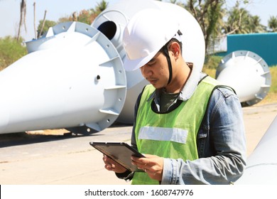 Mechanic Engineer Holds An IPad In A Champagne Bucket Factory