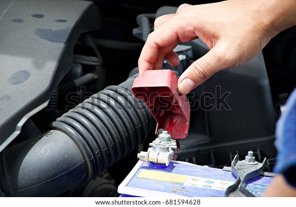 Mechanic is fixing\
car