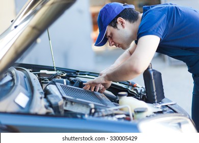 Mechanic Fixing A Car Engine