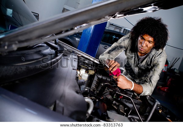 Mechanic fixing a car at the\
garage
