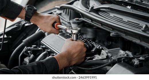 Mechanic fixing a car at home. Repair and service. - Powered by Shutterstock