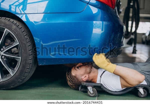 Mechanic fixing car at\
car service station