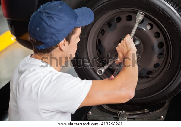 Mechanic Fixing Car\
Tire