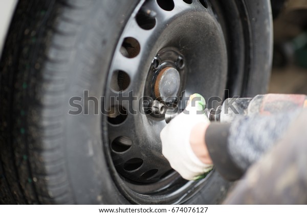 Mechanic Fixing Car\
Tire.