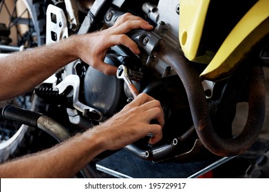 mechanic fixing motocycle engine - Powered by Shutterstock