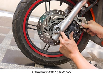 mechanic fixing motocycle  worn motorcycle drum breaks shoes - Powered by Shutterstock