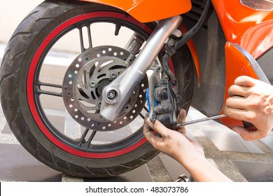 mechanic fixing motocycle  worn motorcycle drum breaks shoes - Powered by Shutterstock