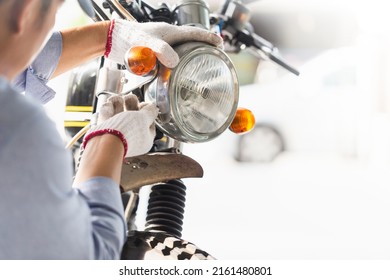 Mechanic Fixing Motorbike In Workshop Garage, Man Repairing Motorcycle In Repair Shop, Repairing And Maintenance