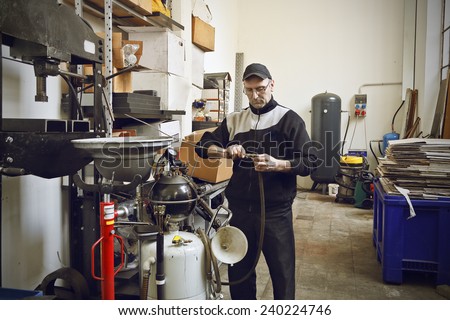 Mechanic fixing something , soft focus