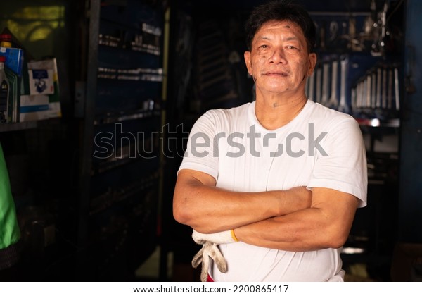 Mechanic\
in the garage. Auto mechanic working in\
garage,