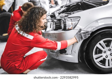 Mechanic garage auto workshop team working service repair fix damaged front bumper accident car