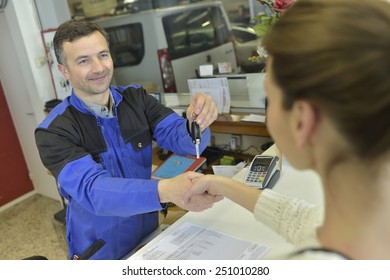 Mechanic Giving Keys Back To Car Owner