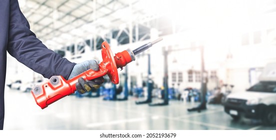 Mechanic Hand Holding A Front Shock Absorber Of The Car In The Repair Garage