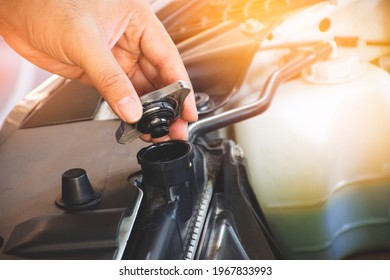 Mechanic Hand Is Opening The Radiator Cap To Check The Coolant Level Of The Car Radiator