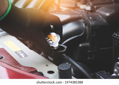 Mechanic Hand Was Opening The Radiator Cap To Check The Coolant Level Of The Car Radiator