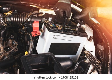 The Mechanic Hand Is Pulling Up An Car Old Battery For Replacement