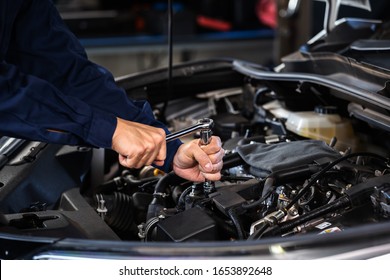 mechanic hand using wrench to repair the engine, car service