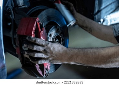 Mechanic Hands Detail During A Maintenance Of Car Brakes