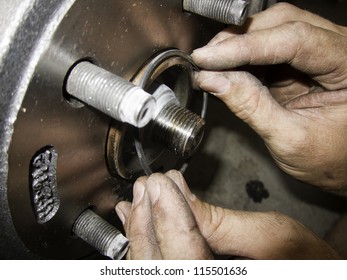 Mechanic Hands Fixing Car Brakes And Rotors Rubber Gasket