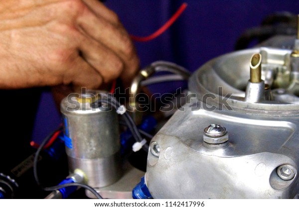 Mechanic hands\
installing nitrous oxide\
set-up