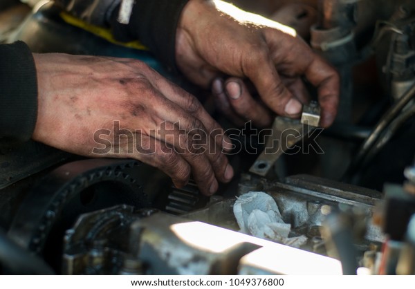 Mechanic hands in oil repair a\
car