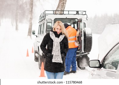 Mechanic helping woman with broken car snow assistance road winter