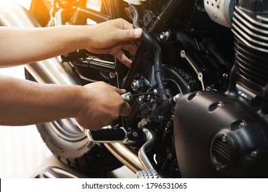 mechanic hold Hex Key Wrench working on motorcycle at motorbike garage , concept of motorcycle maintenance and repair.selective focus                          - Powered by Shutterstock